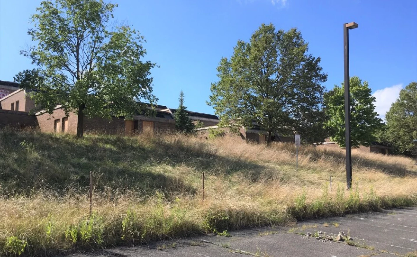 Deteriorating buildings sprawl across the 47-acre site. The city has been maintaining and securing the site since seizing it in 2019, when this photo was taken.